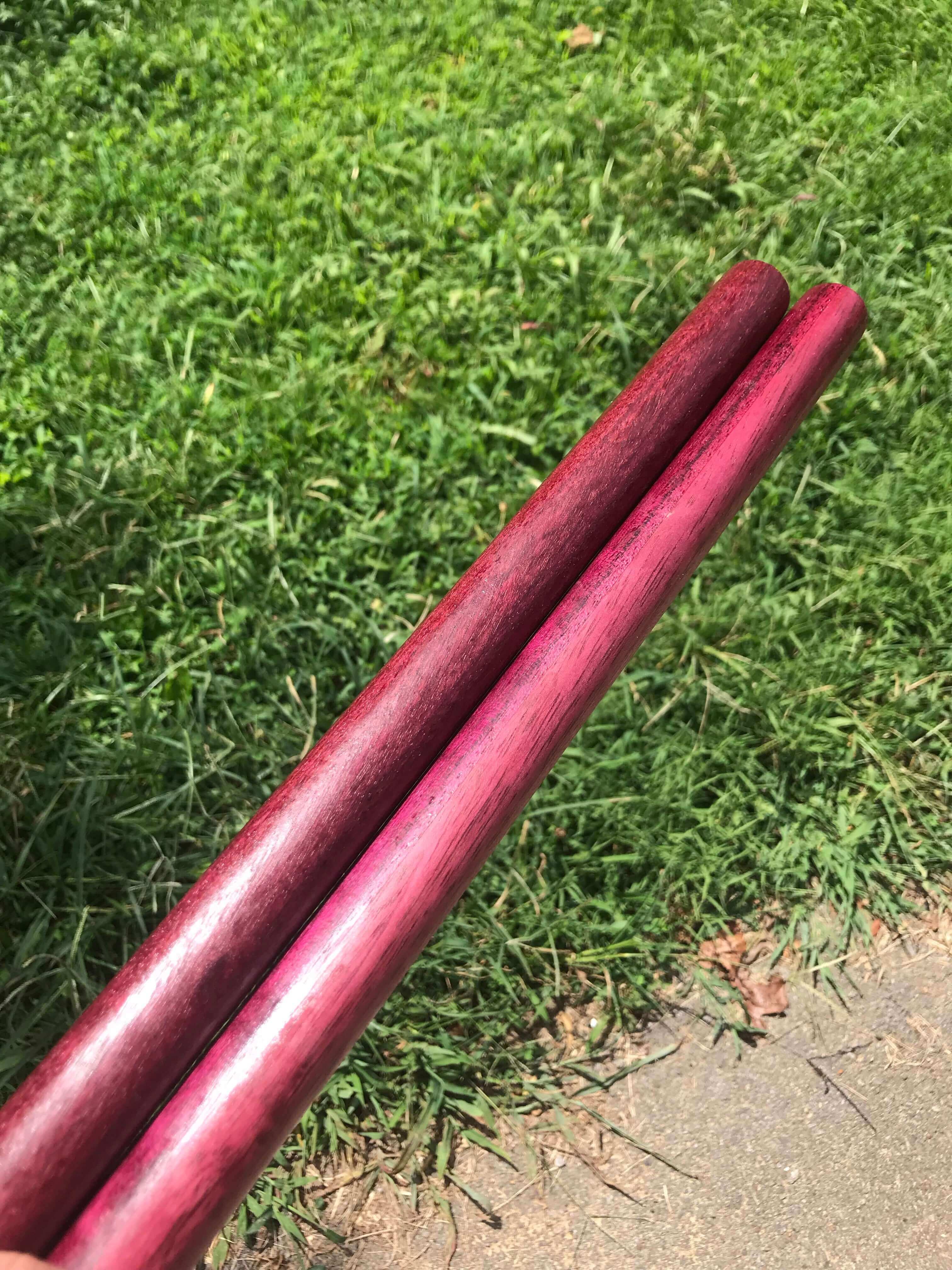 Holding Escrima Sticks made out of Purpleheart.